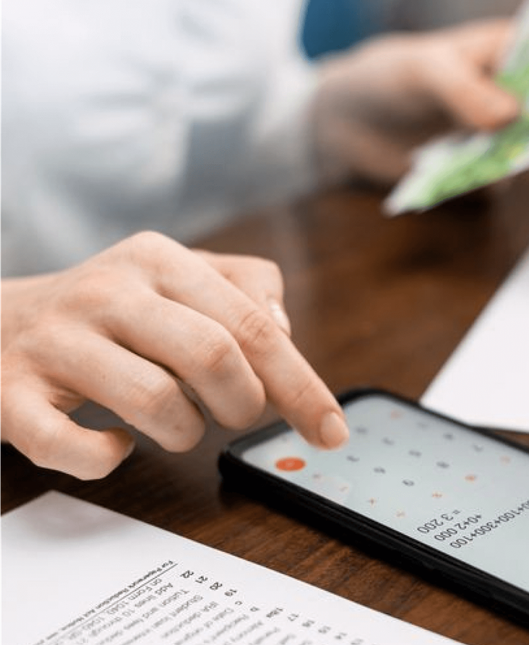 Person calculating on calculator on mobile