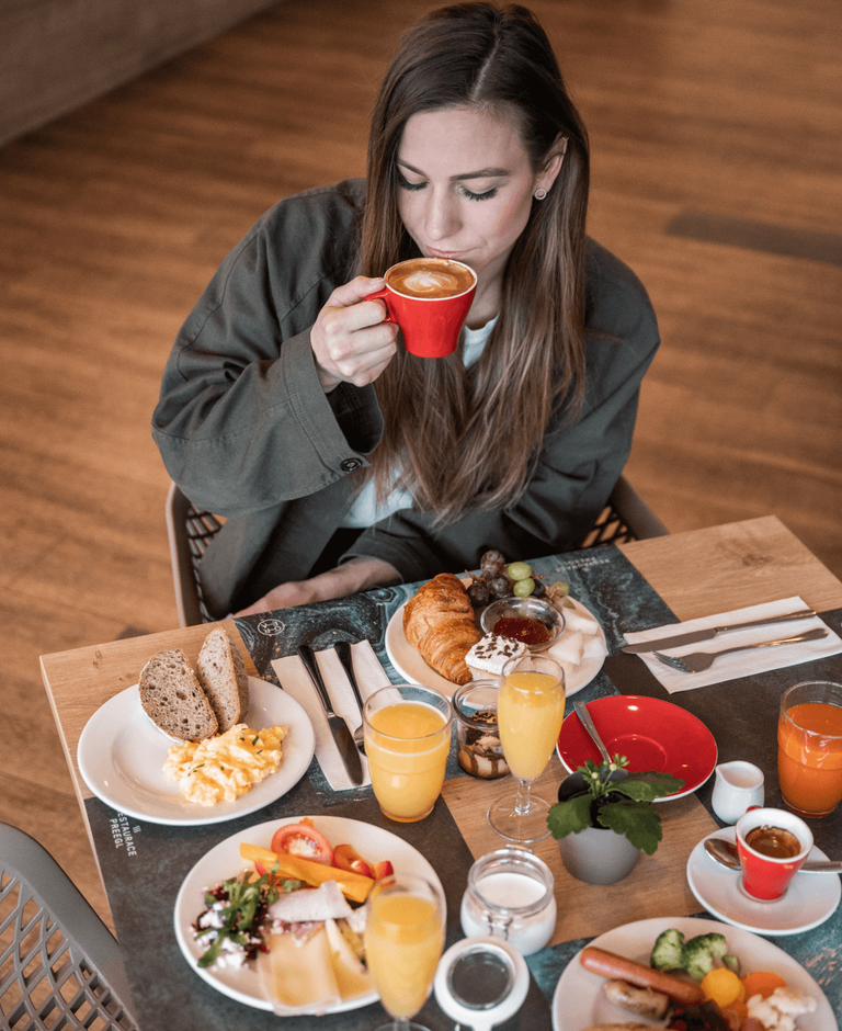 Woman enjoying breakfast at Orea hotel